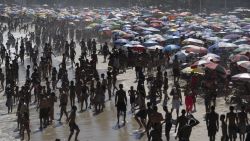 People enjoy the day at Copacabana beach in Rio de Janeiro, Brazil, on February 16, 2025. (Photo by Pablo PORCIUNCULA / AFP) (Photo by PABLO PORCIUNCULA/AFP via Getty Images)          
