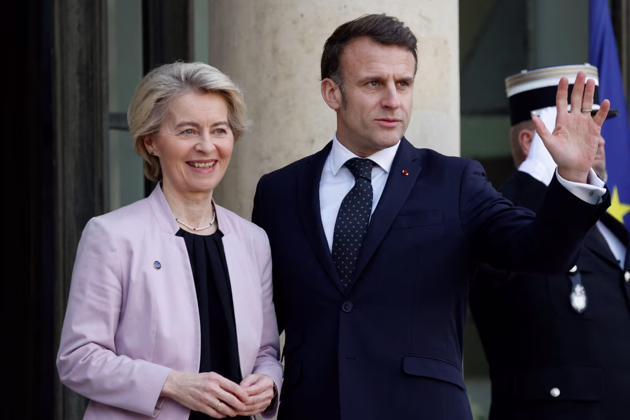 French President Emmanuel Macron welcomes European Commission President Ursula von der Leyen before talks in Paris on Monday.