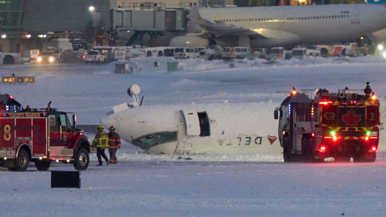 A Delta airlines plane sits on its roof after crashing upon landing at Toronto Pearson Airport in Toronto, Ontario, on February 17, 2025. A Delta Air Lines jet with 80 people onboard crash landed Monday at the Toronto airport, officials said, flipping upside down and leaving at least 15 people injured but causing no fatalities. The Endeavor Air flight 4819 with 76 engers and four crew was landing at around 3:30 pm in Canada's biggest metropolis, having flown from Minneapolis in the US state of Minnesota, the airline said. (Photo by Geoff Robins / AFP) (Photo by GEOFF ROBINS/AFP via Getty Images)