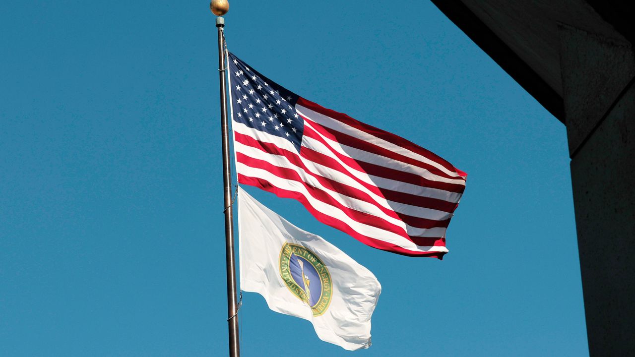 WASHINGTON, DC - FEBRUARY 14: United States and U.S. Department of Energy flags fly near the department's headquarters on February 14, 2025 in Washington, DC. U.S. President Donald Trump’s administration announced the lay offs of 1,200 to 2,000 workers, including probationary employees, at the Department of Energy. (Photo by Anna Moneymaker/Getty Images)