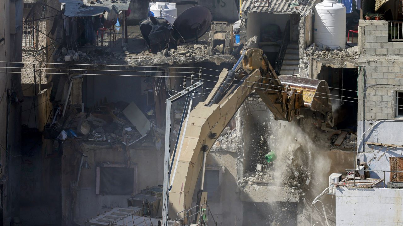 An Israeli excavator demolishes a building during a raid in the Tulkarem camp for Palestinian refugees as part of an ongoing Israeli military operation in the occupied West Bank on February 18, 2025. Since January 21, the Israeli military has been conducting a major operation in the "triangle" of Jenin, Tubas and Tulkarem, where half a million Palestinians live. (Photo by Jaafar ASHTIYEH / AFP) (Photo by JAAFAR ASHTIYEH/AFP via Getty Images)