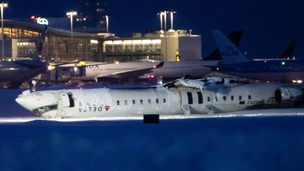 TORONTO, CANADA - FEBRUARY 18: A Delta Air Lines plane that crashed and injured at least 18 engers at Toronto Pearson International Airport is seen on February 18, 2025 in Toronto, Canada. The jet, coming in from Minneapolis, attempted to land amid strong winds and snow, leading to it crashing and landing upside down on the tarmac the day before. (Photo by Katherine KY Cheng/Getty Images)