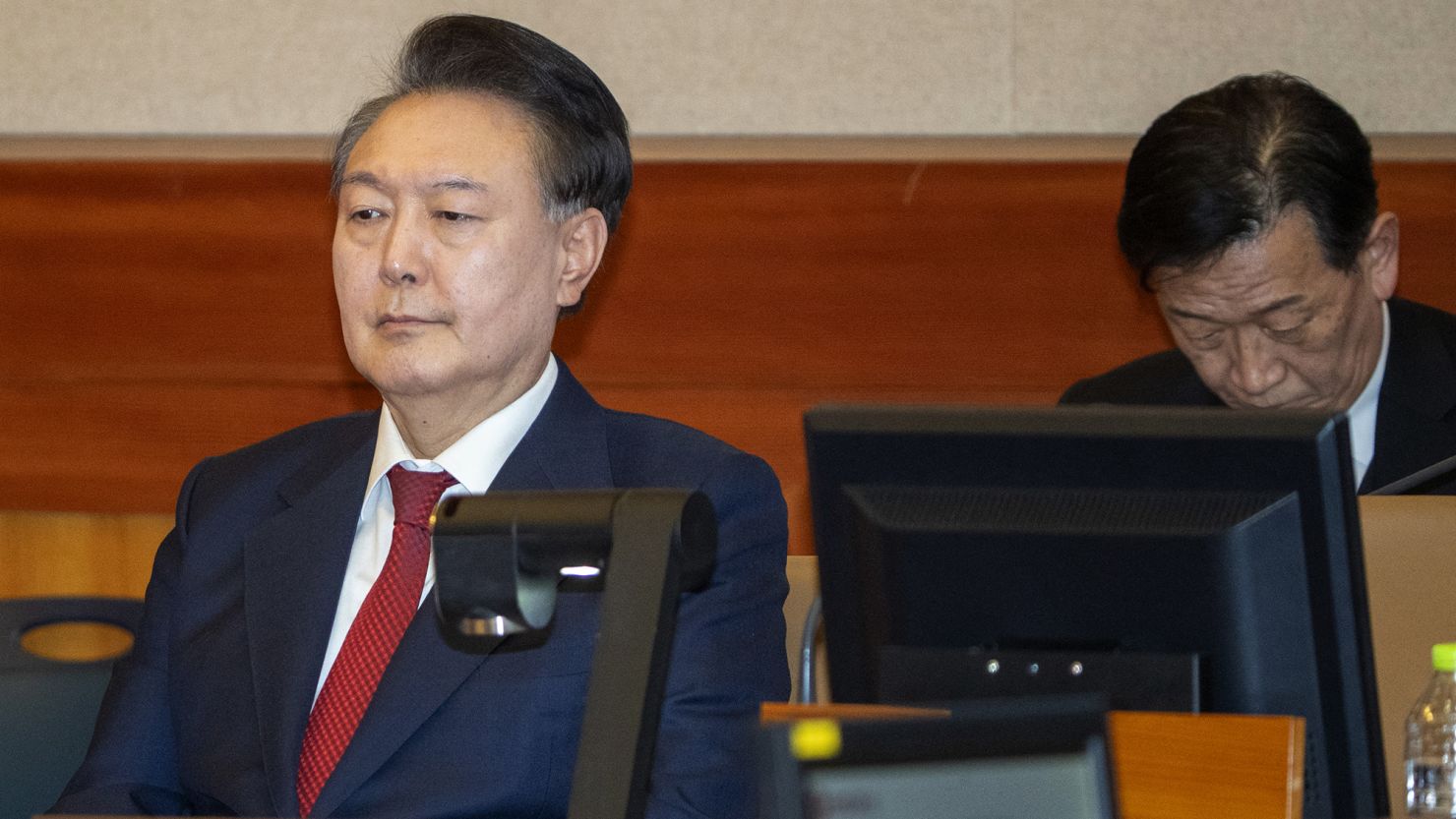 South Korea's impeached President Yoon Suk Yeol, left, attends his impeachment trial in Seoul on February 20, 2025.