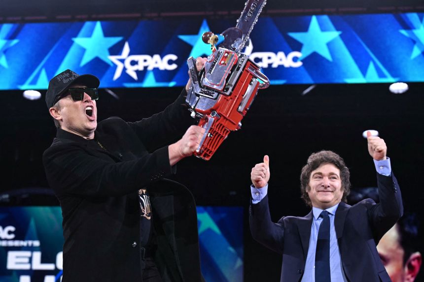Elon Musk holds a chainsaw alongside Argentine President Javier Milei during the annual Conservative Political Action Conference in Oxon Hill, Maryland, on February 20.