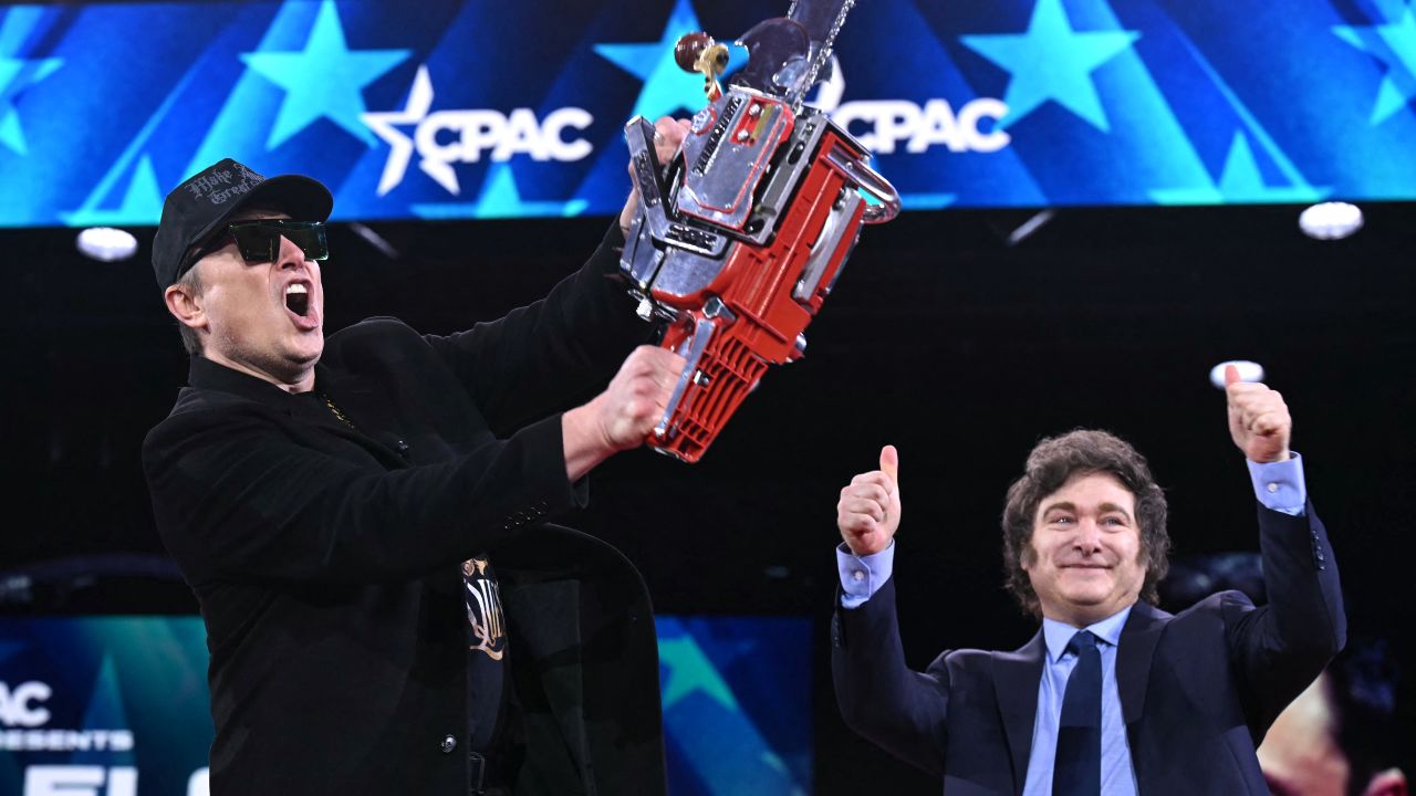 TOPSHOT - Elon Musk (L) holds a chainsaw alongside Argentine President Javier Milei during the annual Conservative Political Action Conference (AC) at the Gaylord National Resort & Convention Center at National Harbor in Oxon Hill, Maryland, on February 20, 2025. The chainsaw was a present to Elon Musk from Argentina's President Javier Milei. (Photo by SAUL LOEB / AFP) (Photo by SAUL LOEB/AFP via Getty Images)          