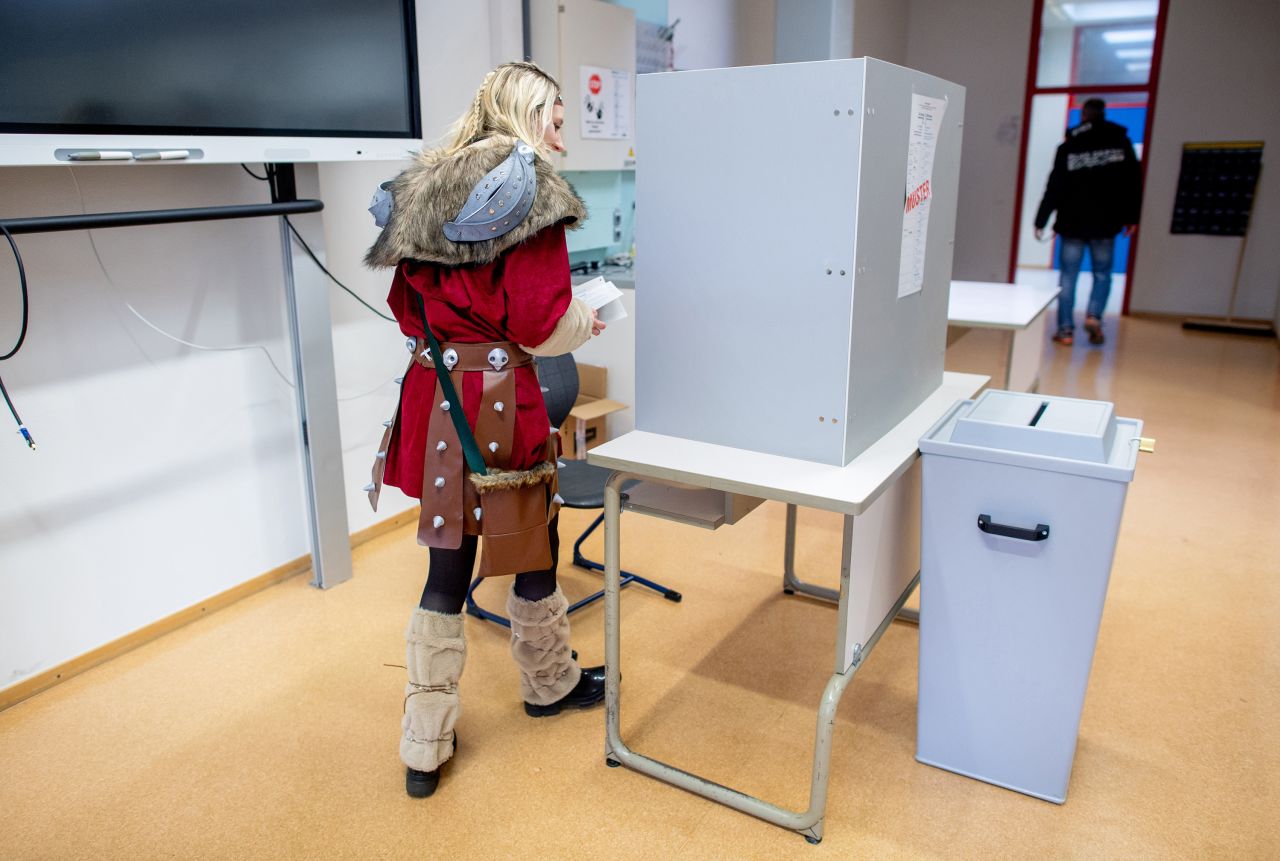 23 February 2025, Lower Saxony, Damme: Costumed voter Linda goes behind a screen to cast her vote at a polling station. The early election to the 21st German Bundestag takes place on Sunday. In Damme, Lower Saxony, the Bundestag election coincides with the traditional Damme carnival, which is traditionally celebrated a week before the actual Rose Monday. Photo: Hauke-Christian Dittrich/dpa (Photo by Hauke-Christian Dittrich/picture alliance via Getty Images)