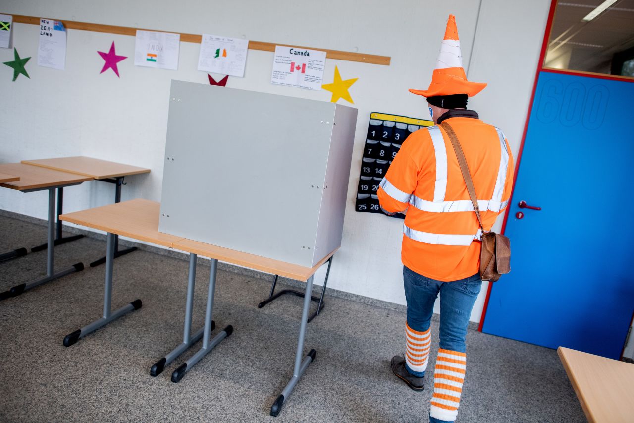 23 February 2025, Lower Saxony, Damme: Costumed voter Henrik goes behind a screen to cast his vote at a polling station. The early election to the 21st German Bundestag takes place on Sunday. In Damme, Lower Saxony, the Bundestag election coincides with the traditional Damme carnival, which is traditionally celebrated a week before the actual Rose Monday. Photo: Hauke-Christian Dittrich/dpa (Photo by Hauke-Christian Dittrich/picture alliance via Getty Images)