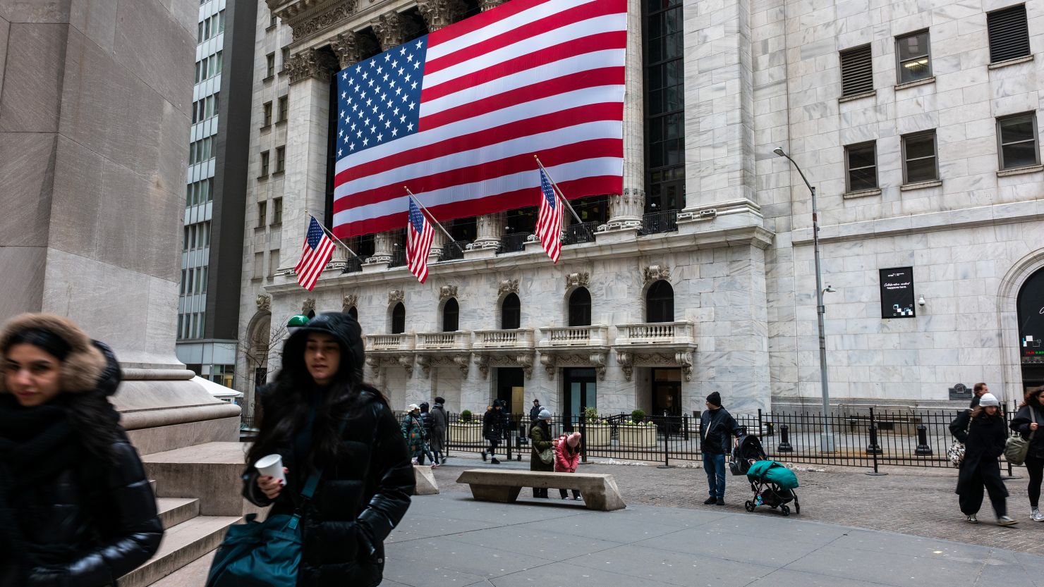 People walk by the New York Stock Exchange in New York City.