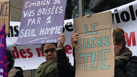 Protestors hold signs reading "How man lives broken by only one man" and "Silence kills" outside the Criminal Court in Vannes, on February 24, 2025, on the opening day of retired surgeon Joel Le Scouarnec's four-month trial on charges of assaulting or raping 299 patients. French retired surgeon Joel Le Scouarnec, 74, will face a new four-month trial starting in Vannes on February 24, on charges of assaulting or raping 299 patients. Most of the 299 victims were minors at the time, 256 were under the age of 15, and they were often asleep. He is already in prison after a court in 2020 found him guilty of abusing four children, including the rape of two of his nieces. (Photo by Damien MEYER / AFP) (Photo by DAMIEN MEYER/AFP via Getty Images)          