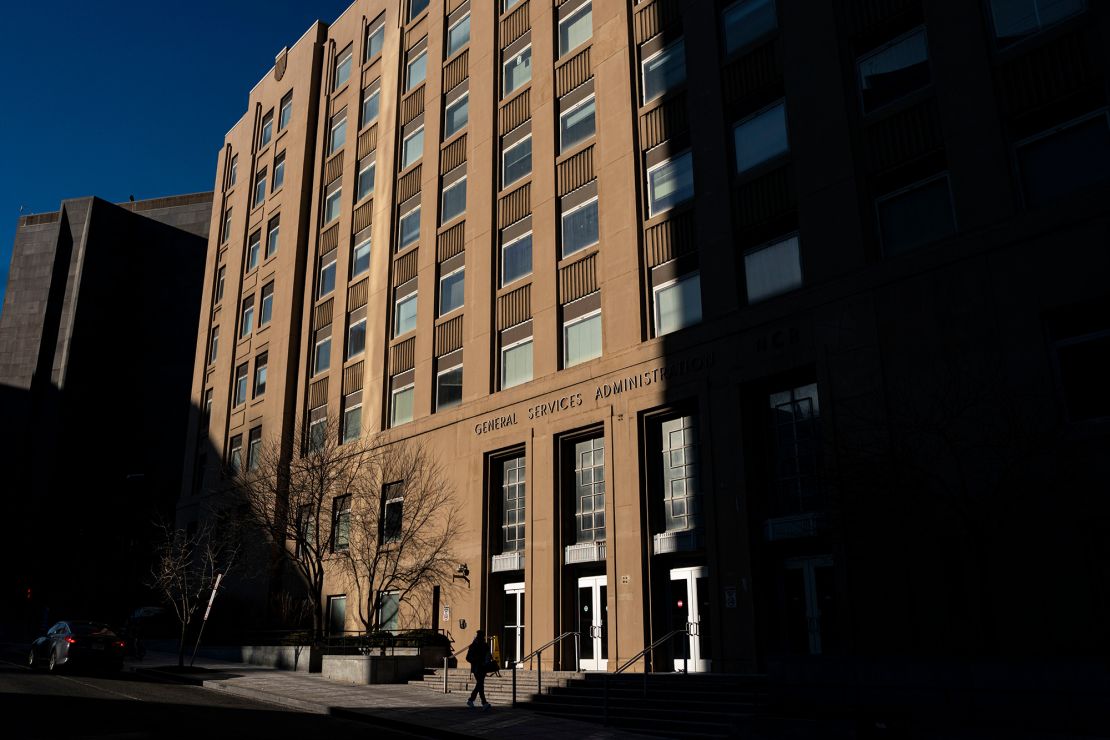 A pedestrian near a General Services Administration (GSA) building in Washington, DC, US, on Monday, Feb. 24, 2025. Reports that DOGE is using AI as part of its efforts to reshape the federal government are raising concerns among technology experts.