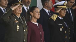 Mexico's President Claudia Sheinbaum (C) flanked by Defense Minister Ricardo Trevilla Trejo (L) and Secretary of the Navy iral Raymundo Pedro Morales Angeles attends a military ceremony to commemorate the Mexican Flag Day at Marte Military Sports Field in Mexico City on February 24, 2025. (Photo by Yuri CORTEZ / AFP) (Photo by YURI CORTEZ/AFP via Getty Images)          