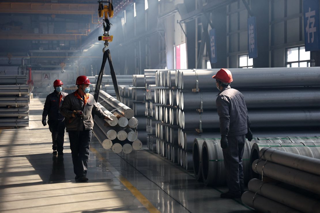 Workers transport aluminum rods at a factory in Binzhou, in eastern China's Shandong province, in February 2025. Tariffs on aluminum shipped from China to the US rose to 45% this week.