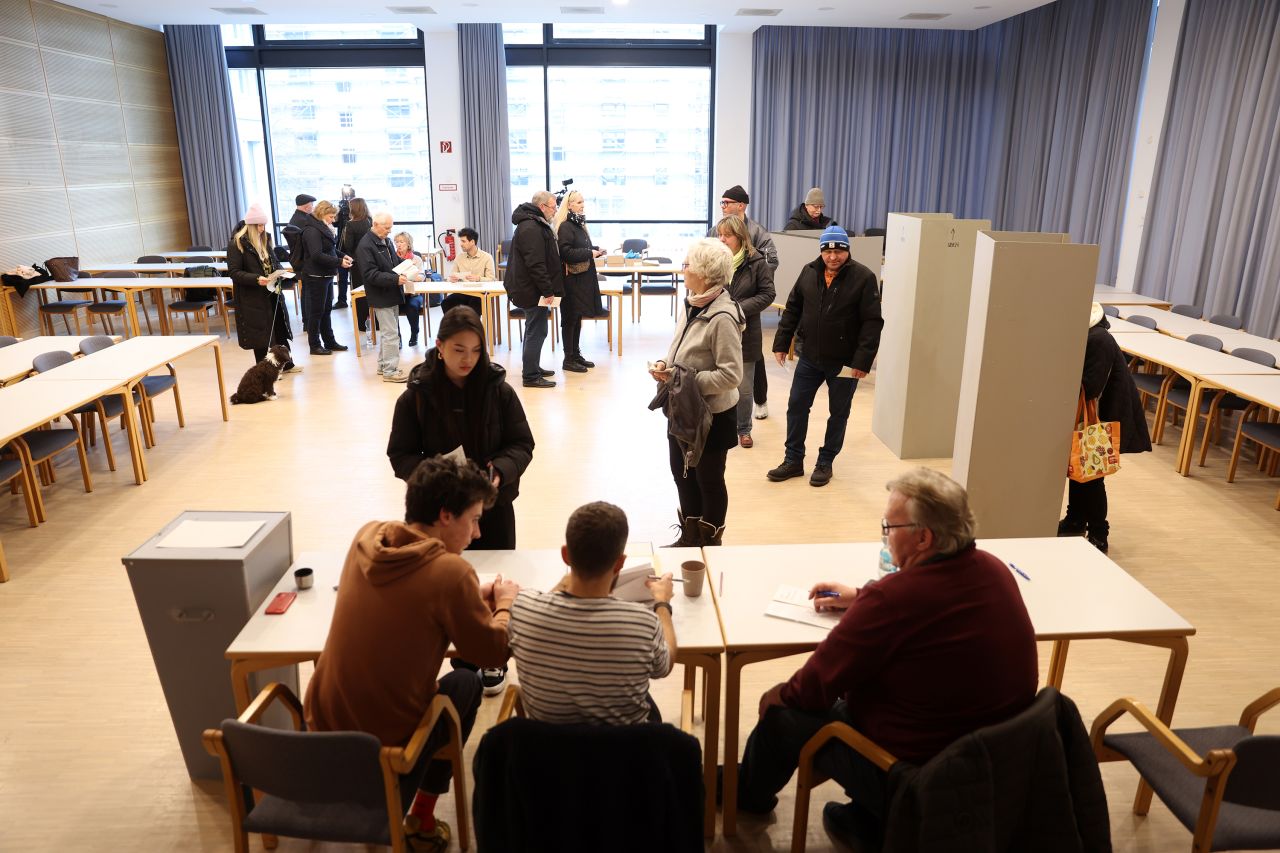 BERLIN, GERMANY - FEBRUARY 23: Voters arrive at a polling station to cast their ballots in snap federal parliamentary elections on February 23, 2025 in Berlin, Germany. Germany is holding elections today following the collapse of the three-party government coalition last November. (Photo by Maryam Majd/Getty Images)