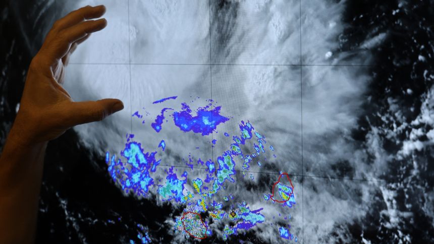 A Meteo-France operational meteorologist monitors tropical cyclone "Garance" approaching French overseas territory island of La Reunion, in Saint-Denis de la Reunion on February 26, 2025. La Reunion is placed under a cyclonic orange alert since 2:00 pm (11:00 am in Paris) on February 26, 2025 due to storm "Garance", which could intensify into a cyclone, the prefecture of the French Indian Ocean island announced. (Photo by Richard BOUHET / AFP) (Photo by RICHARD BOUHET/AFP via Getty Images)