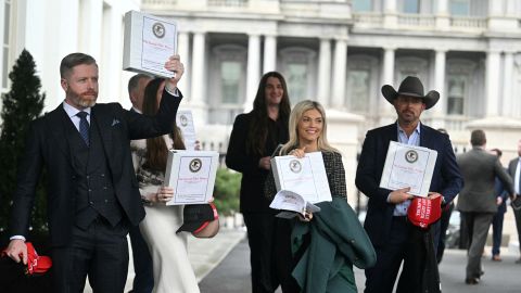 Political commentator Rogan O'Handley, aka DC Draino, TikToker Chaya Raichik, US conservative activist Scott Presler, commentator Liz Wheeler and US conservative political commentator Chad Prather carry binders bearing the seal of the US Justice Department reading "The Epstein Files: Phase 1."