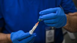 A health worker prepares a dose of the measles vaccine at a health center in Lubbock, Texas, on February 27, 2025. Dozens of children are being rushed to a health center in the US state of Texas to get the measles vaccine, after the recent death in the area of a child who was not immunized against the highly contagious virus. The death came as immunization rates have declined nationwide, with the latest cases in the west Texas town of Lubbock concentrated in a Mennonite religious community that has historically shown vaccine hesitancy. (Photo by RONALDO SCHEMIDT / AFP) (Photo by RONALDO SCHEMIDT/AFP via Getty Images)          