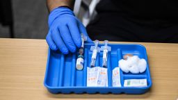 A health worker prepares a dose of the measles vaccine at a health center in Lubbock, Texas, on February 27, 2025. Dozens of children are being rushed to a health center in the US state of Texas to get the measles vaccine, after the recent death in the area of a child who was not immunized against the highly contagious virus. The death came as immunization rates have declined nationwide, with the latest cases in the west Texas town of Lubbock concentrated in a Mennonite religious community that has historically shown vaccine hesitancy.