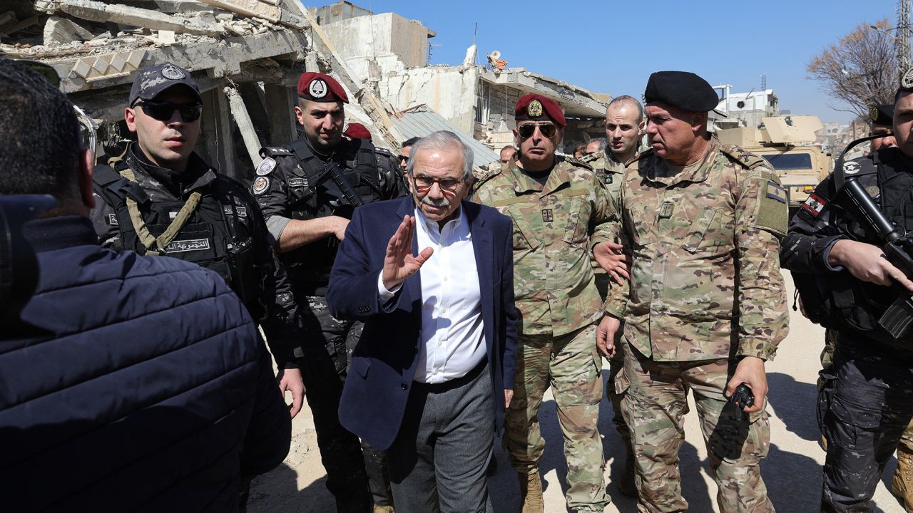 Lebanon's Prime Minister Nawaf Salam walks among Lebenese army soldiers as he visits the sourthern village of Khiam near the border with Israel, on February 28, 2025, after the withdrawal last December of Israeli forces from the area under a ceasefire deal with Hezbollah. Israel stepped up its campaign in south Lebanon in late September after nearly a year of cross-border exchanges begun by Hezbollah in support of Hamas following its Palestinian ally's October 7, 2023 attack on southern Israel. A ceasefire came into effect on November 27.