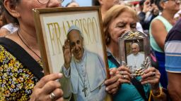 BUENOS AIRES, ARGENTINA - FEBRUARY 24: Catholic faithful carry images of Pope Francis at an outdoor mass to pray for him on February 24, 2025 in Buenos Aires, Argentina. Born in Buenos Aires and the first Pope ever chosen from the Americas, Pope Francis was hospitalized in Rome on February 14 with bronchitis, and was subsequently treated for a respiratory tract infection. The Vatican confirmed on Monday that the pope is still in critical condition but he could sleep, wake up and eat. (Photo by John Moore/Getty Images)