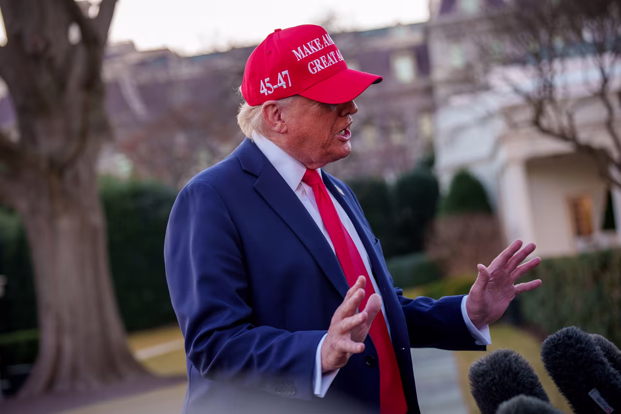 President Donald Trump speaks to members of the media before boarding Marine One on the South Lawn of the White House on Friday.