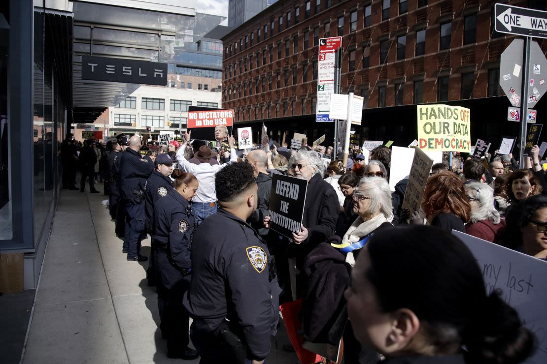 La gente participa en una protesta "TeslaTakedown" contra Elon Musk fuera de un concesionario de Tesla en Nueva York, 1 de marzo de 2025.