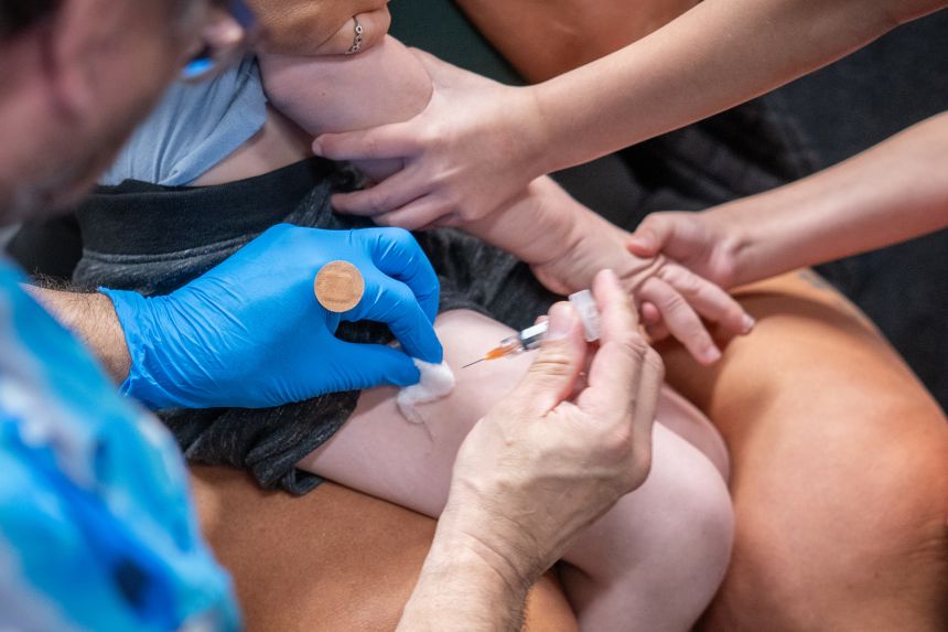 A young child receives the measles-mumps-rubella vaccine in Texas.