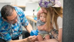 LUBBOCK, TEXAS - MARCH 01: One year-old River Jacobs is held by his mother, Caitlin Fuller, while he receives an MMR vaccine from Raynard Covarrubio, at a vaccine clinic put on by Lubbock Public Health Department on March 1, 2025 in Lubbock, Texas. Cases of Measles are on the rise in West Texas as over 150 confirmed case have been seen with one confirmed death.(Photo by Jan Sonnenmair/Getty Images)