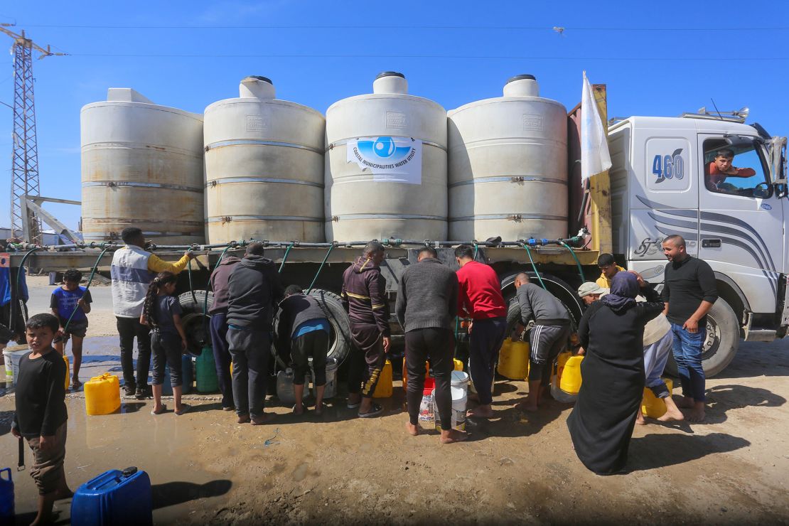 Displaced Palestinians staying in makeshift tents in the al-Mawasi area try to meet their daily needs by filling water jerry cans with water distributed by tankers in Khan Younis, Gaza on Sunday.