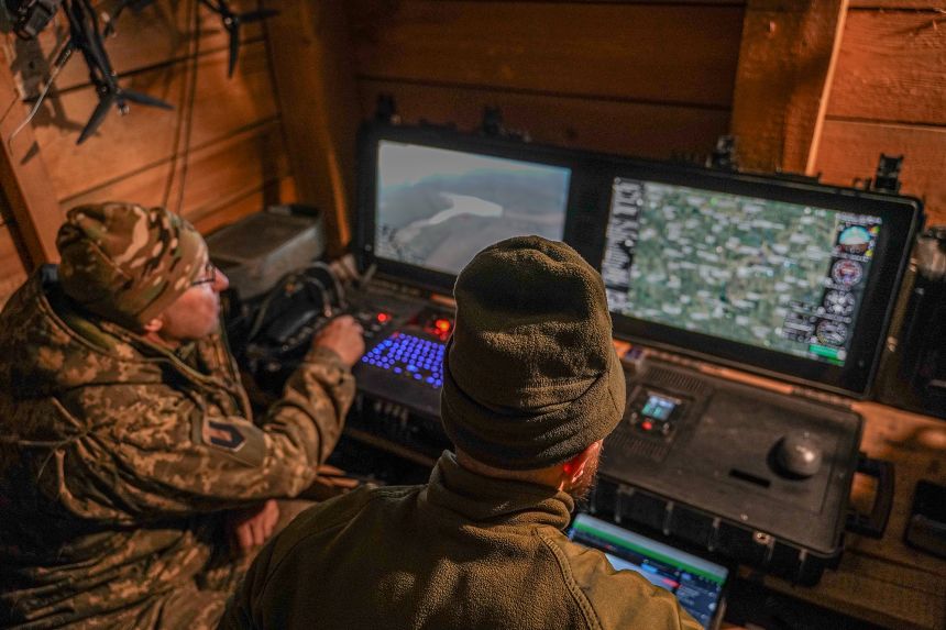 Ukrainian soldiers watch their monitors as a drone conducts reconnaissance on February 12, 2025 in the Donetsk region of Ukraine.