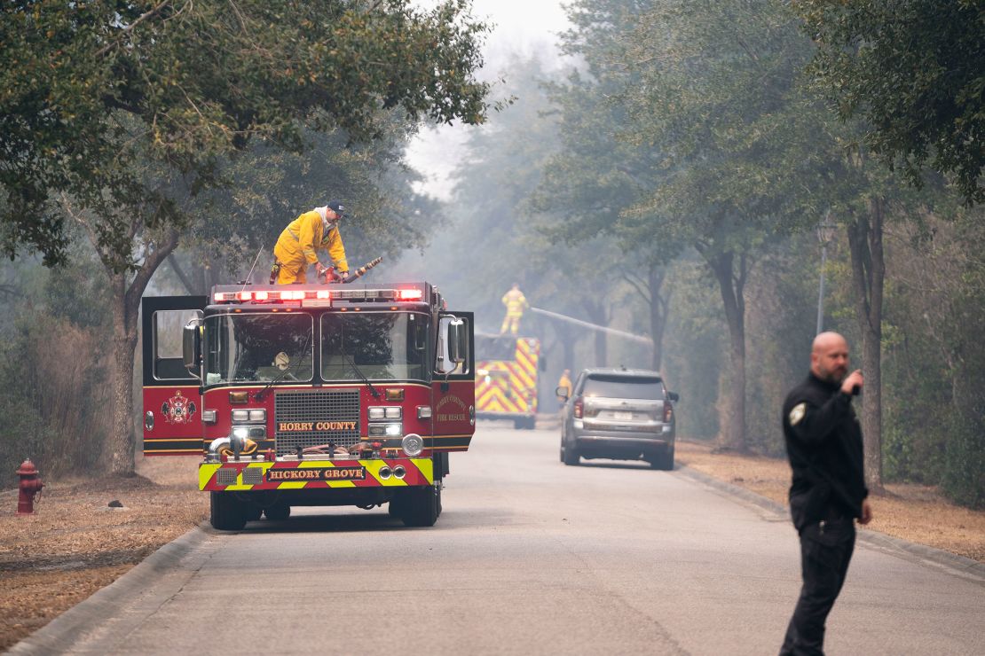 Firefighters battle a blaze in the Carolina Forest neighborhood on March 2, 2025, in Myrtle Beach, South Carolina.