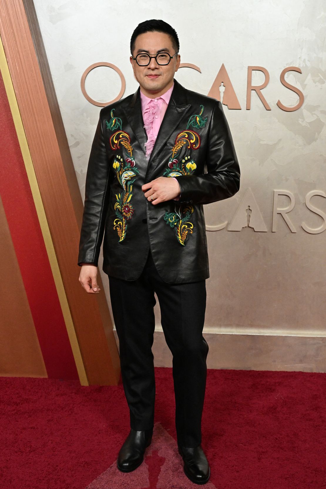 Bowen Yang, who helped reveal the list of nominees in January, wore a black leather jacket featuring bright floral patterns by Italian label Etro.