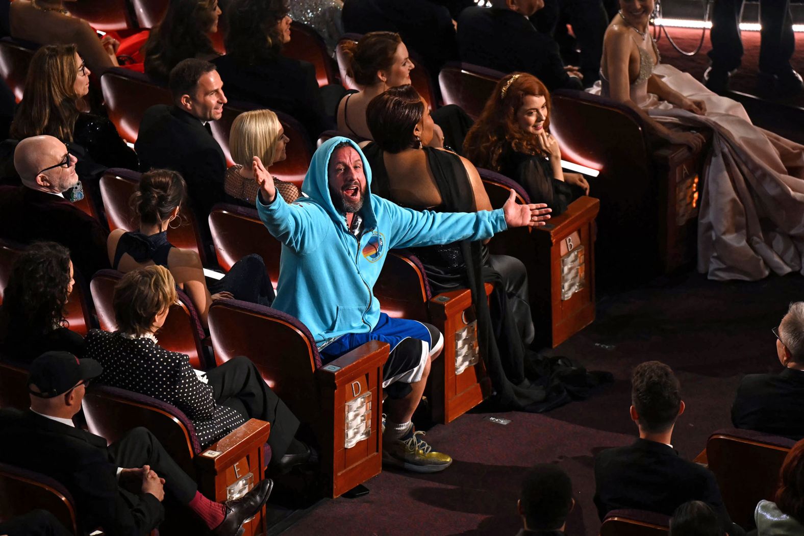 Adam Sandler speaks to O'Brien from the audience after O'Brien made a joke about his clothes during the opening monologue.