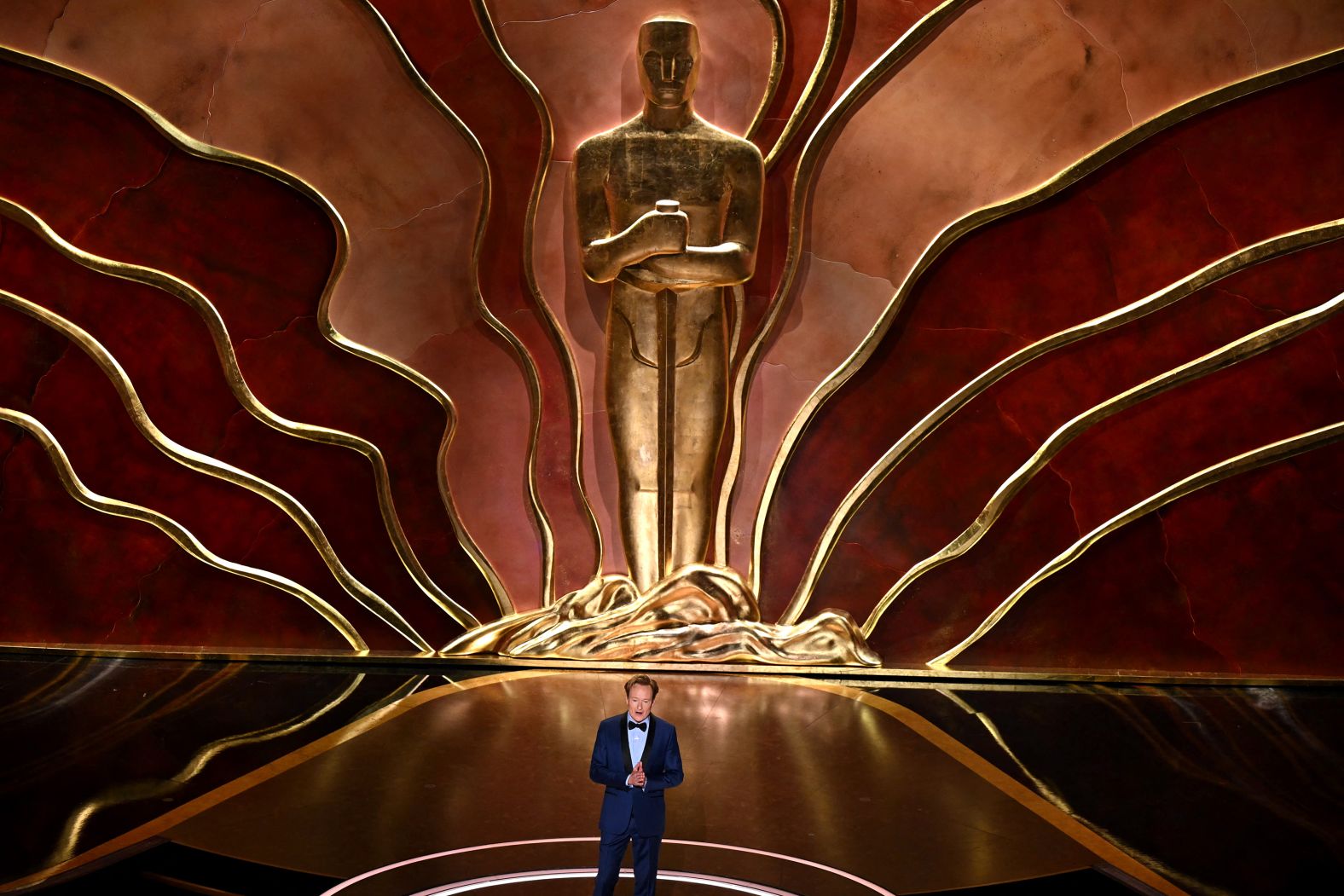 Host Conan O'Brien speaks on stage during the show.