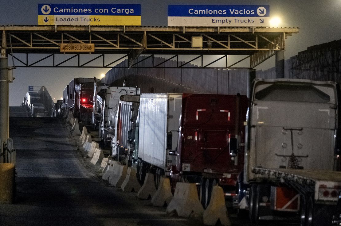 Trucks queue near the Mexico-US border while waiting for the port to open in Otay Commercial crossing in Tijuana, Baja California state, Mexico, on March 4, 2025.