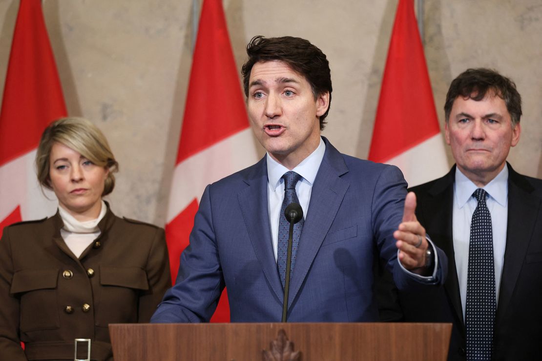 Canada's Prime Minister Justin Trudeau speaks during a news conference about the US tariffs against Canada on March 4, 2025 on Parliament Hill in Ottawa, as Foreign Minister Melanie Joly (L) and Minister of Finance and Intergovernmental Affairs Dominic LeBlanc look on.