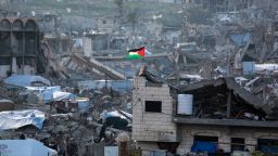 TOPSHOT - A Palestinian flag flutters amid the ruins of buildings in Beit Lahia in the northern Gaza Strip on March 4, 2025, amid the ongoing truce between Israel and Hamas. UN chief Antonio Guterres said he strongly endorsed an Egyptian plan put to Arab leaders at a summit in Cairo on March 4 for Gaza's reconstruction without displacement of its Palestinian inhabitants. (Photo by Bashar TALEB / AFP) (Photo by BASHAR TALEB/AFP via Getty Images)