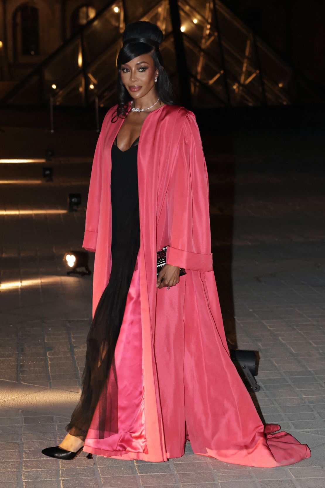 Model Naomi Campbell wore a black slip dress under a brightly colored robe.