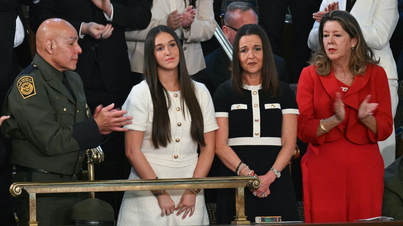 Allyson (2nd R) and Lauren Phillips (2nd L), mother and sister of the late Laken Riley, who was murdered by an undocumented migrant,  stand as they are recognized by US President Donald Trump during Trump's address to a t session of Congress in the House Chamber of the US Capitol in Washington, DC, on March 4, 2025. (Photo by SAUL LOEB / AFP) (Photo by SAUL LOEB/AFP via Getty Images)          