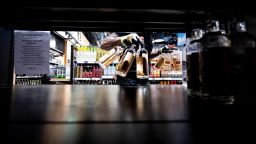 A worker removes bottles of American-made Tito's vodka from a shelf at a Liquor Control Board of Ontario store in Toronto on March 4.
