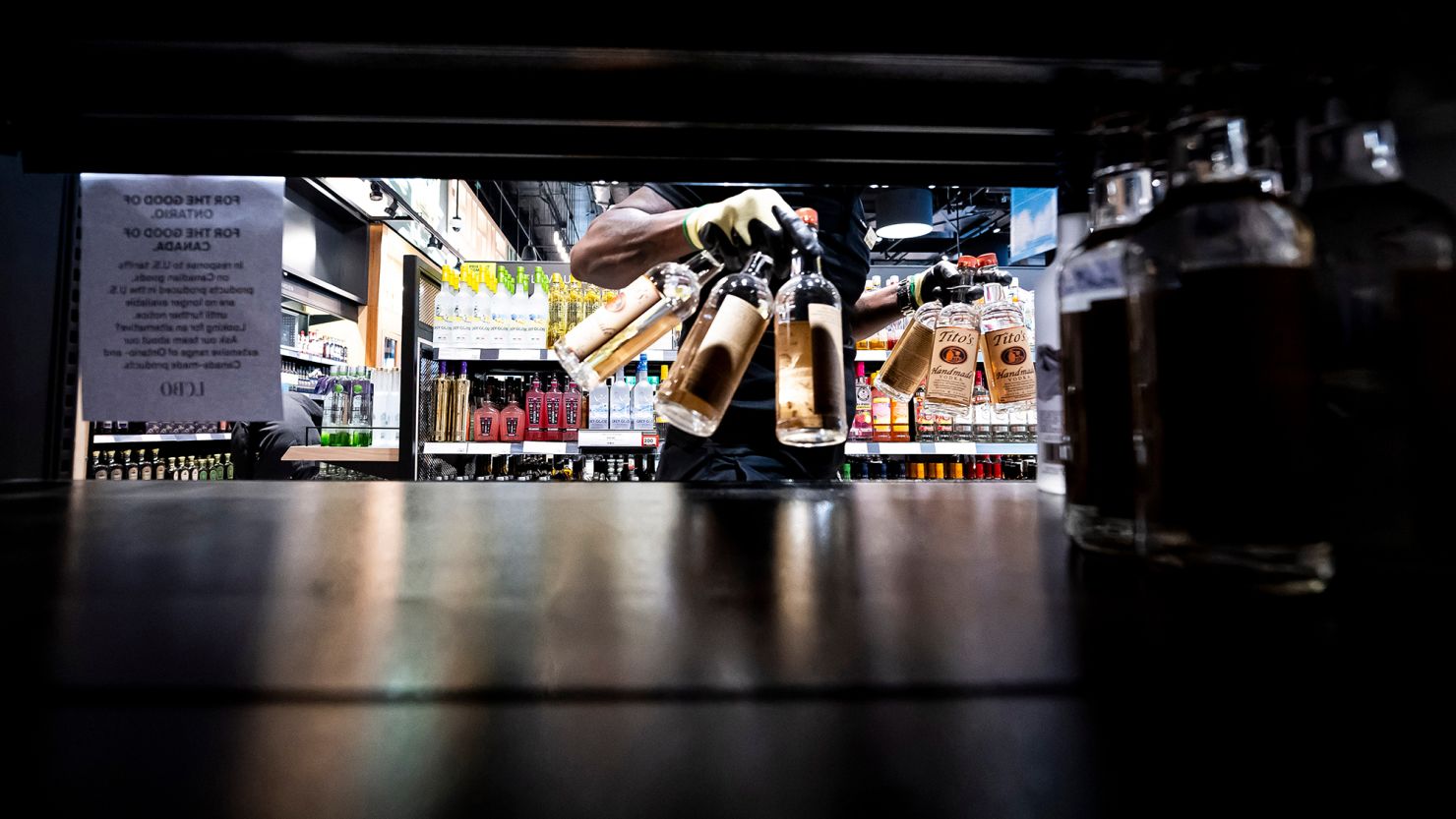 A worker removes bottles of American-made Tito's vodka from a shelf at a Liquor Control Board of Ontario store in Toronto on March 4.