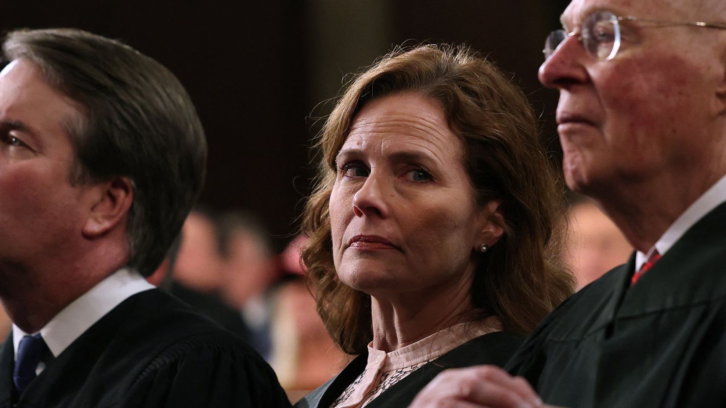 Justice Brett Kavanaugh, left, Justice Amy Coney Barrett, center, and retired Supreme Court Justice Anthony Kennedy listen as US President Donald Trump addresses a joint session of Congress at the US Capitol in Washington, DC, on Tuesday.