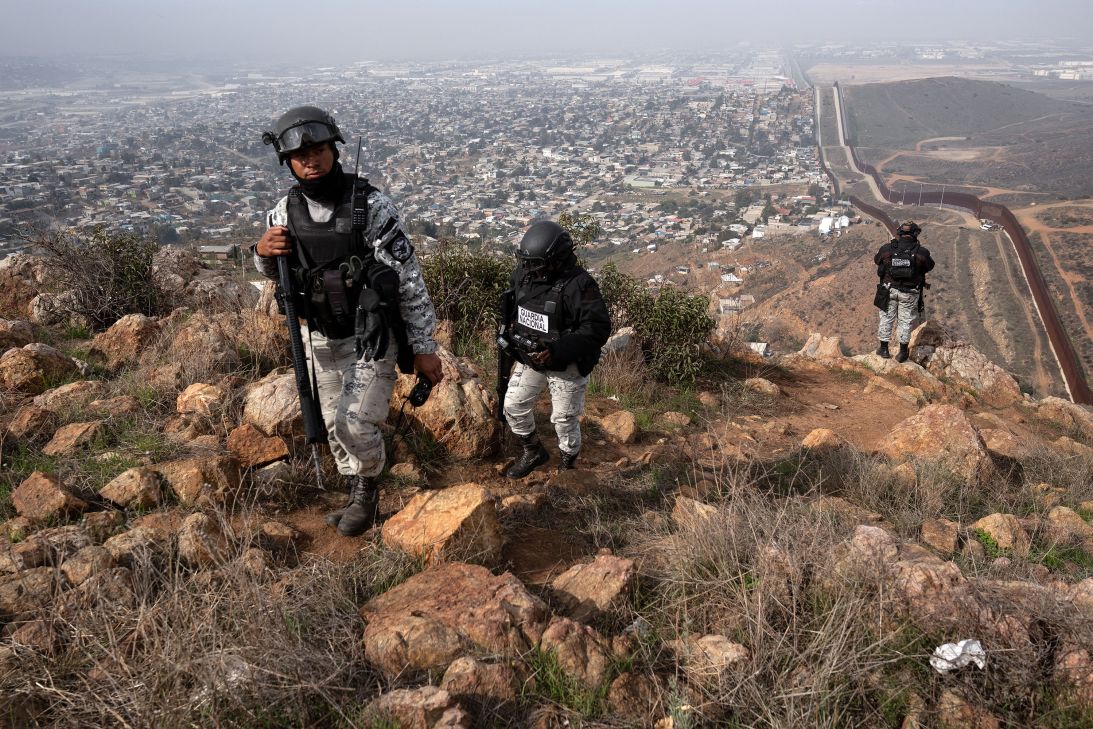 Mexican National Guard officers patrol at a high point of El Nido de las Aguilas in eastern Tijuana, Baja California State, Mexico, on March 5, on the Mexican side of the Mexico-US border.