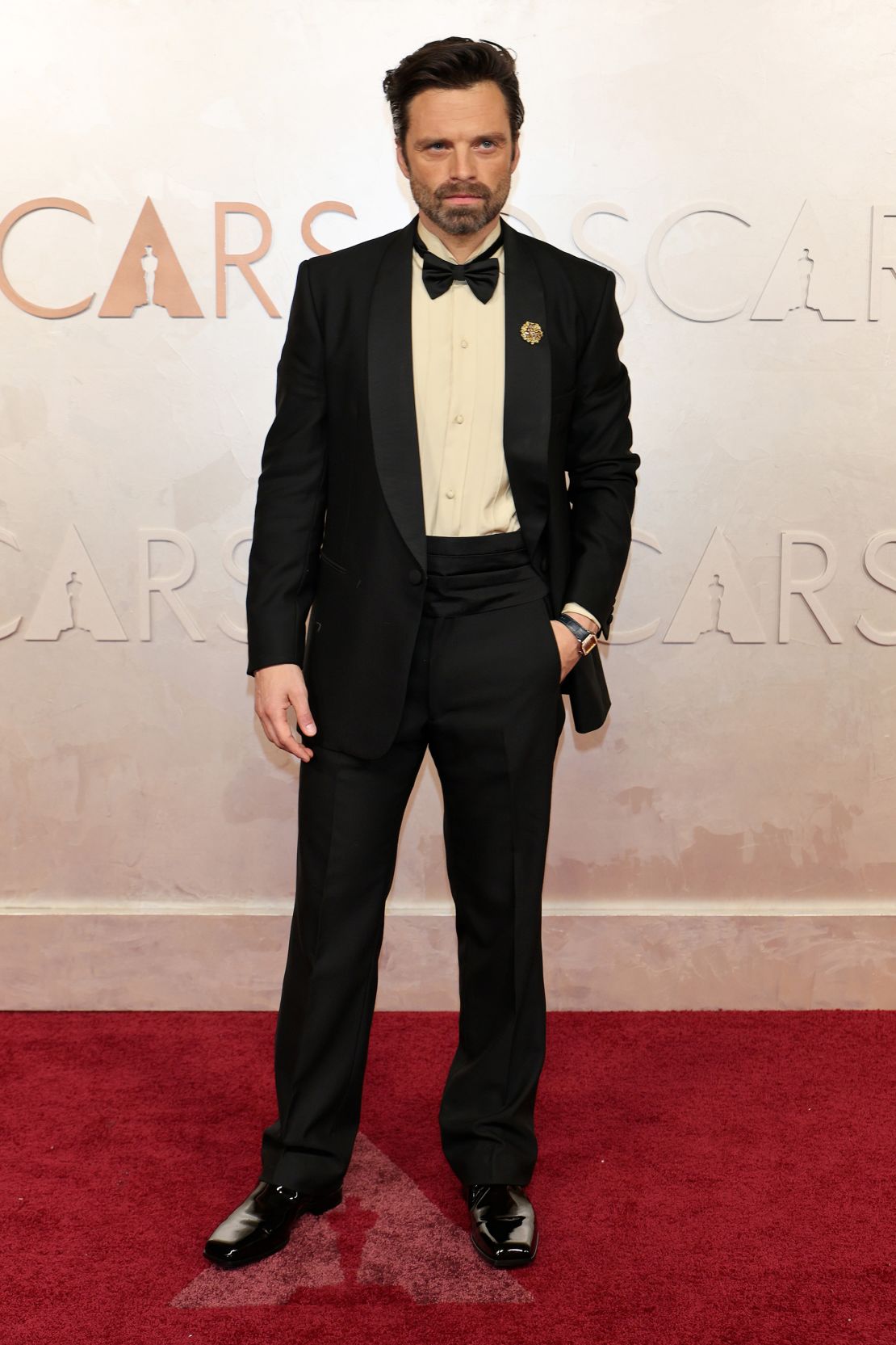 Sebastian Stan, nominee for Best Actor, wore a custom Prada tuxedo with a wool shawl collar and a pale yellow silk poplin shirt. “The Apprentice” star completed the look with a silk bow tie and black patent leather shoes.