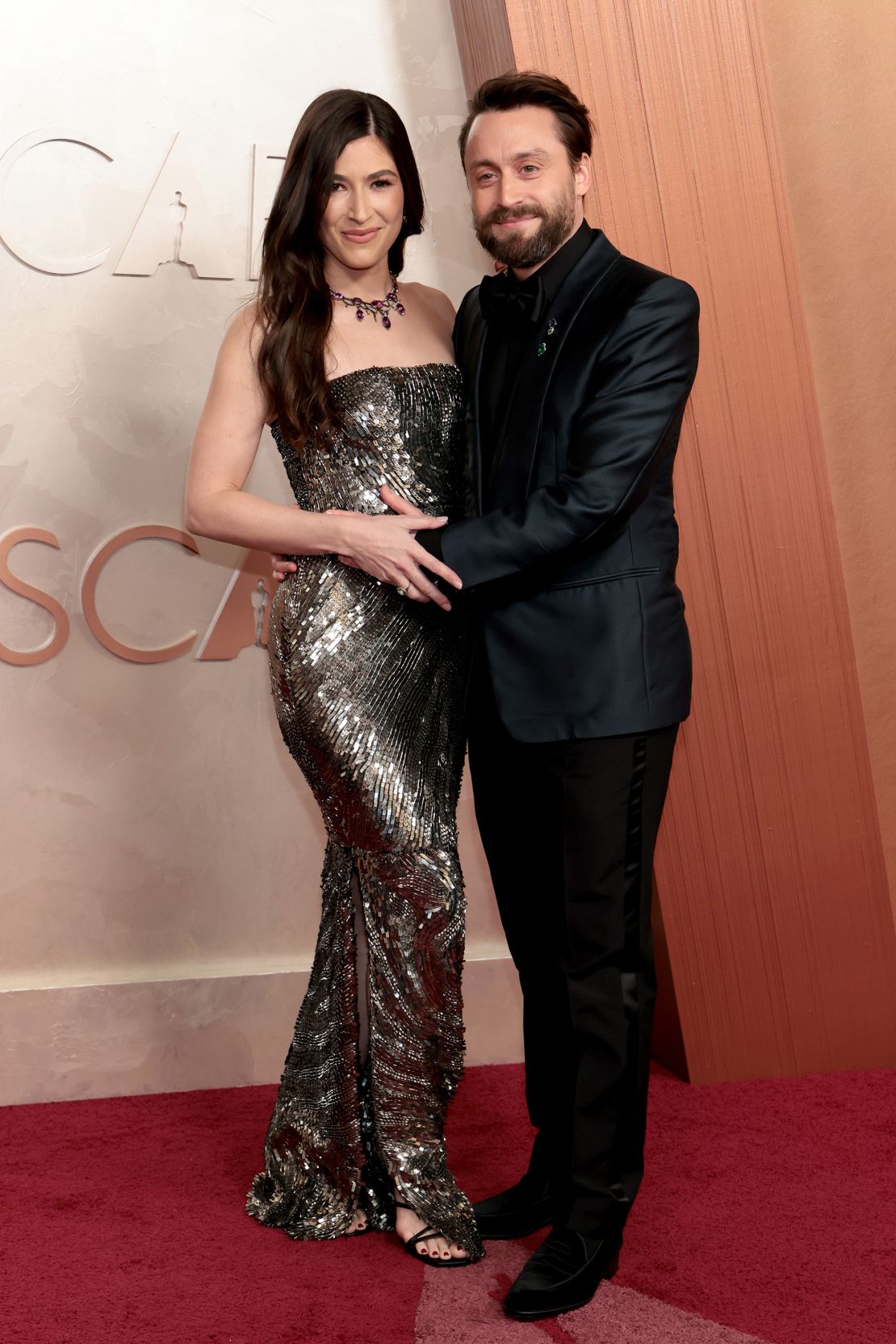 Kieran Culkin, who went on to win Best Supporting Actor for “A Real Pain,” wore an all-black custom Zegna suit with Fred Leighton jewelry and an Omega watch. He is pictured with wife Jazz Charton.