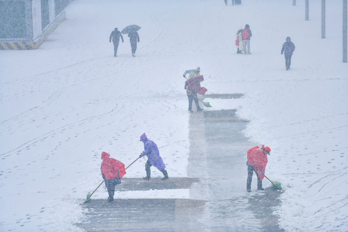 Cleaning staff clear snow at the Jinan West Railway Station in Jinan, China, on March 2.