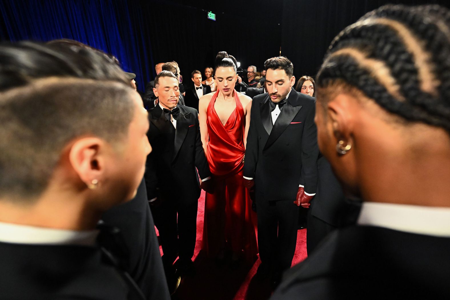 Margaret Qualley and dancers take a moment backstage before the Bond tribute.