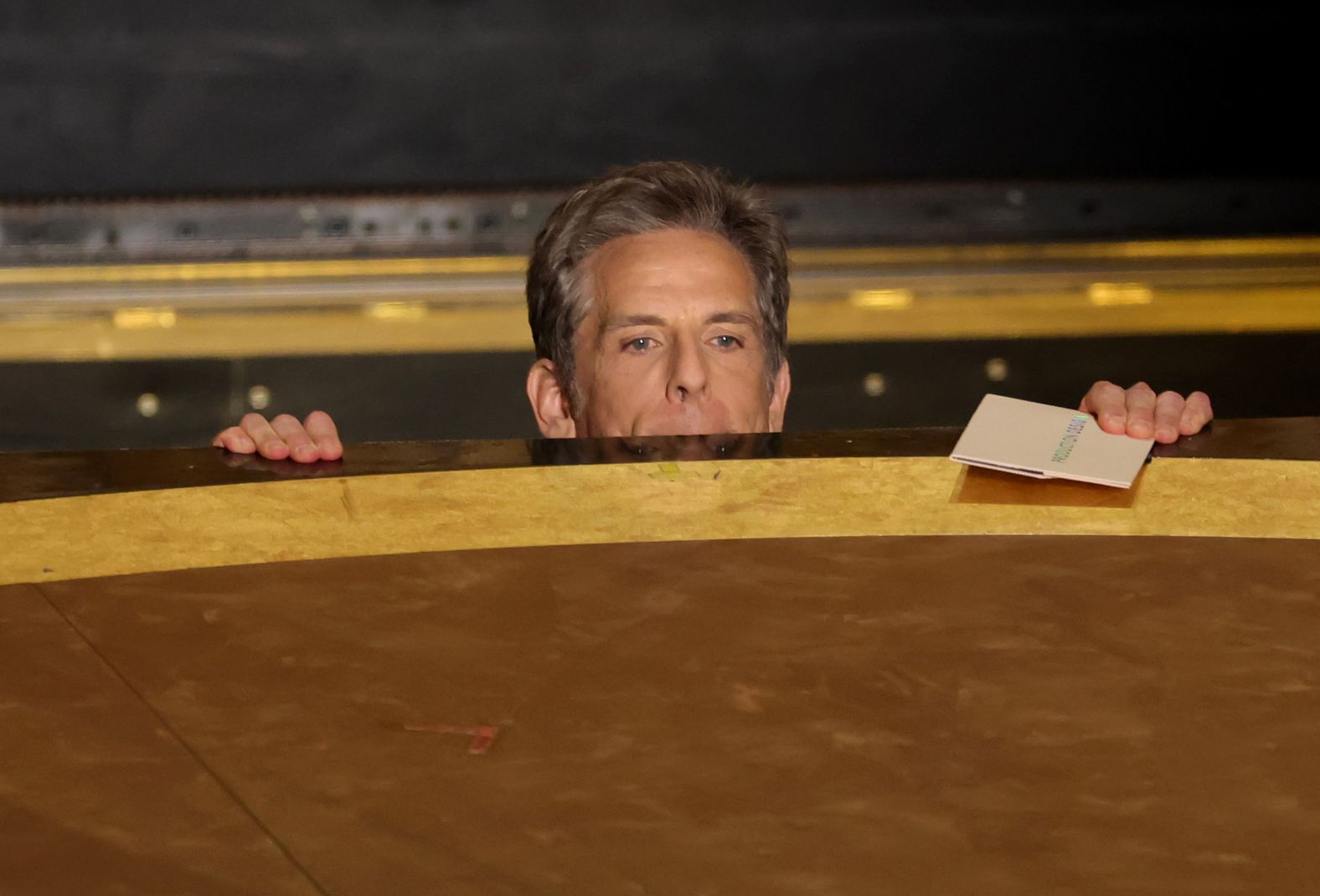 Ben Stiller peeks out from a stage as he presents the Oscar for best production design.