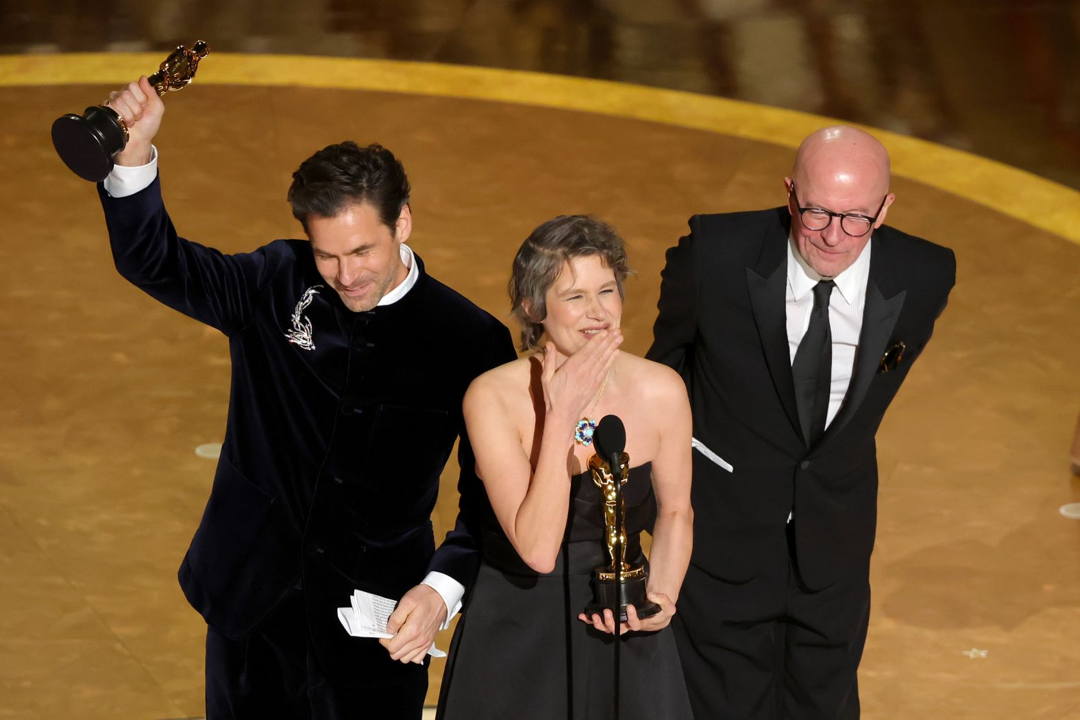 Clément Ducol, Jacques Audiard and Camille Dalmais accept the Oscar for <a href="https://www.cnn.com/entertainment/live-news/oscars-academy-awards-03-02-25#cm7seekzn001h3b6n48w01nyo">best original song</a>, "El Mal" from "Emilia Pérez."