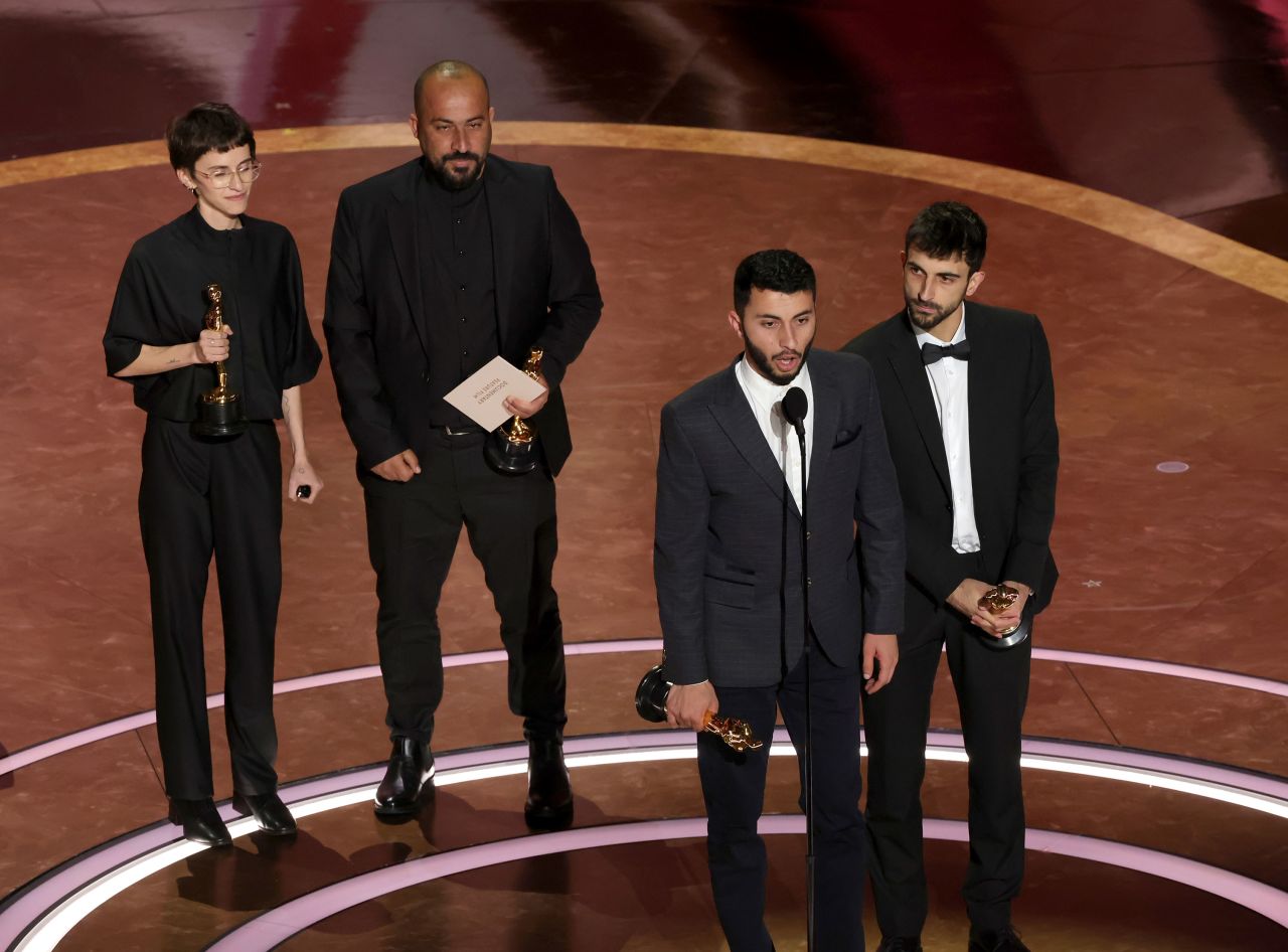 From left, Rachel Szor, Hamdan Ballal, Basel Adra and Yuval Abraham accept award for best documentary feature film for 