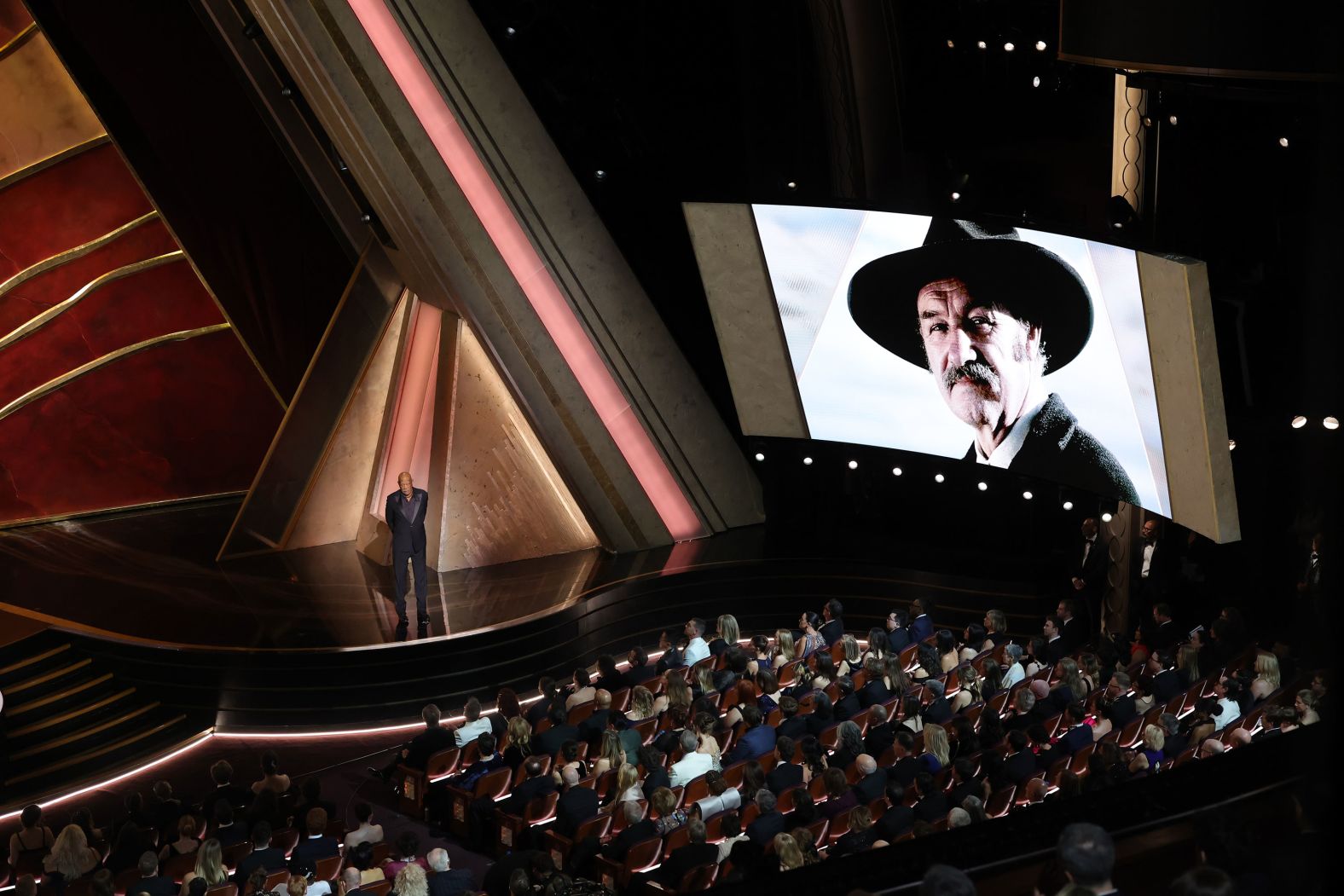 An image of Gene Hackman is seen on screen as Morgan Freeman introduces <a href="https://www.cnn.com/entertainment/live-news/oscars-academy-awards-03-02-25#cm7sfqt9e00193b6mojvq2y5t">the annual In Memoriam segment</a>.